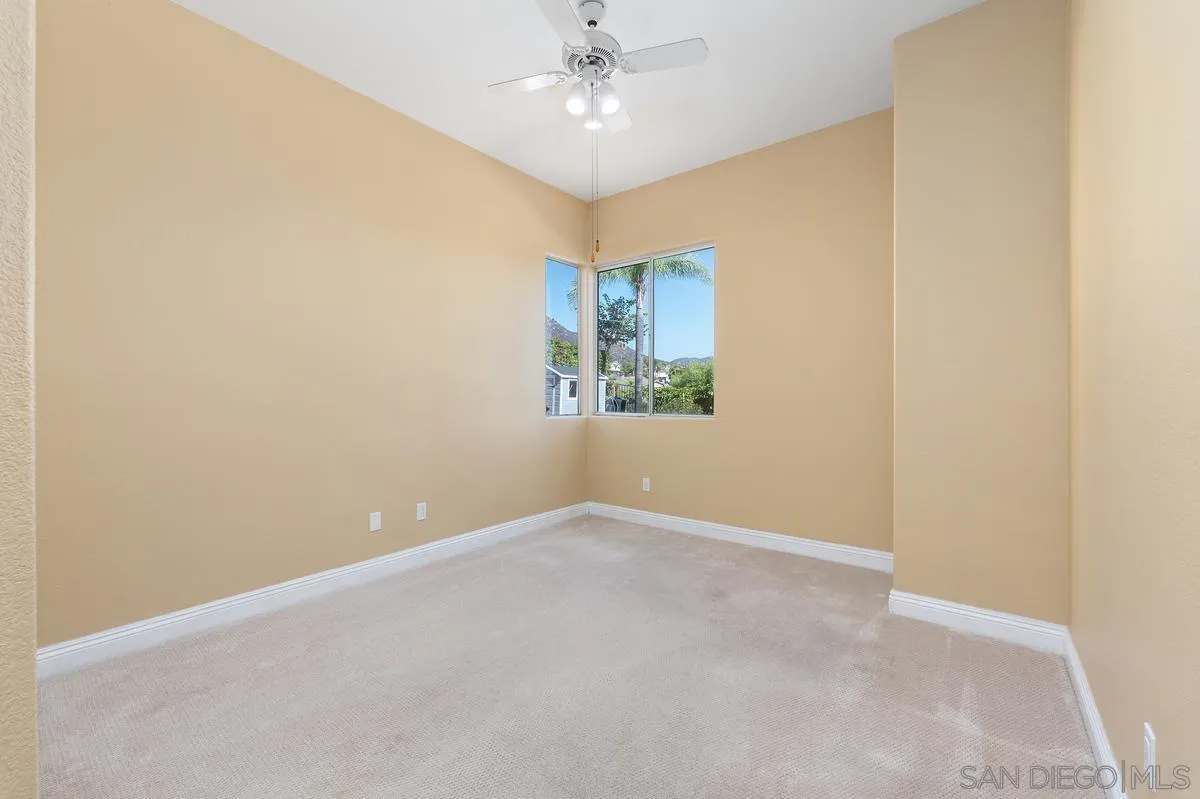 1819 Monarch Ridge Circle El Cajon, CA 92019 - Photo 20 of 60 an empty room with a window and a ceiling fan