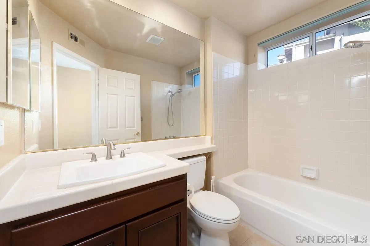 1819 Monarch Ridge Circle El Cajon, CA 92019 - Photo 21 of 60 a bathroom with a sink a toilet a mirror and bathtub