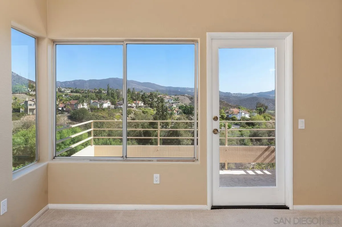 1819 Monarch Ridge Circle El Cajon, CA 92019 - Photo 34 of 60 a living room with a large window and a floor to ceiling window