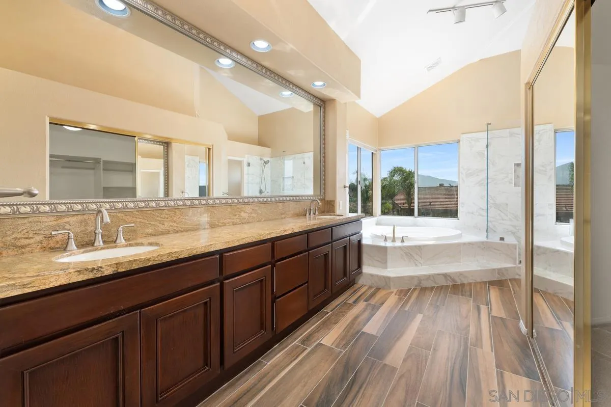 1819 Monarch Ridge Circle El Cajon, CA 92019 - Photo 38 of 60 a large bathroom with a large mirror vanity and a sink