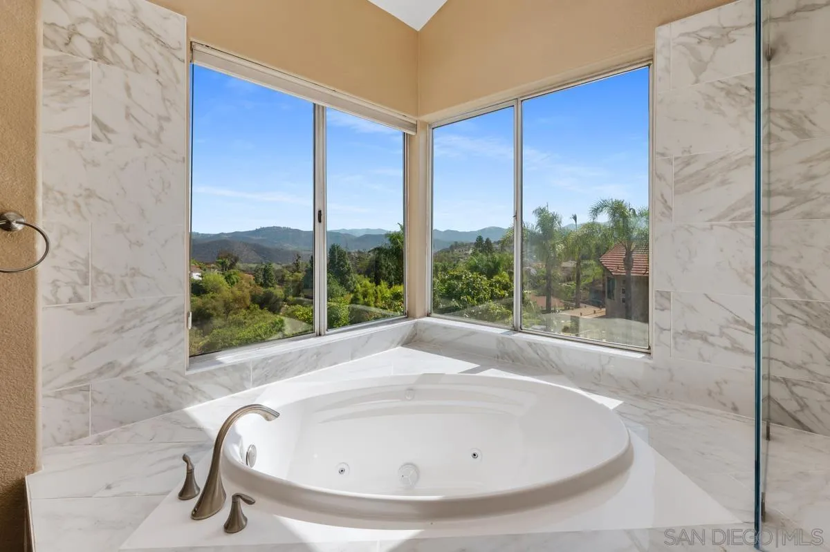 1819 Monarch Ridge Circle El Cajon, CA 92019 - Photo 40 of 60 a bathroom with a bathtub and next to a window