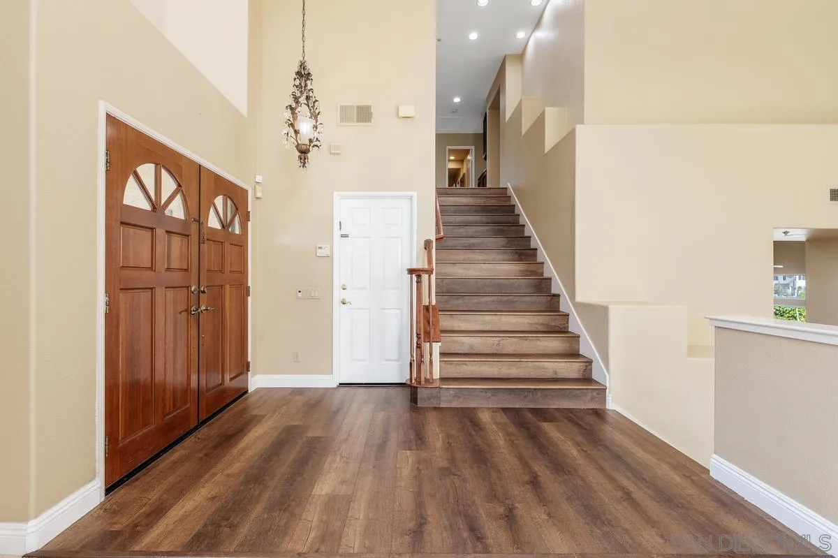 1819 Monarch Ridge Circle El Cajon, CA 92019 - Photo 7 of 60 a view of a hallway with wooden floor and staircase