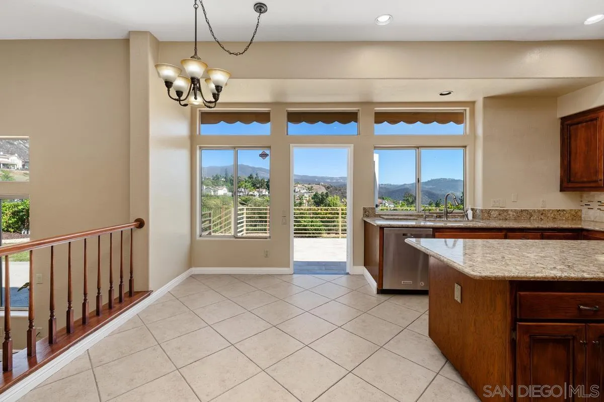 1819 Monarch Ridge Circle El Cajon, CA 92019 - Photo 10 of 60 a large kitchen with kitchen island granite countertop a sink and cabinets