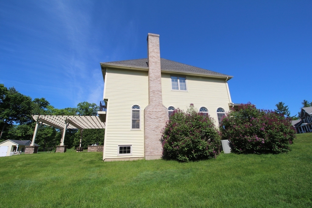 5 Gableview Lane Southwick, MA 01077 - Photo 8 of 41 a front view of a house with a yard and garage