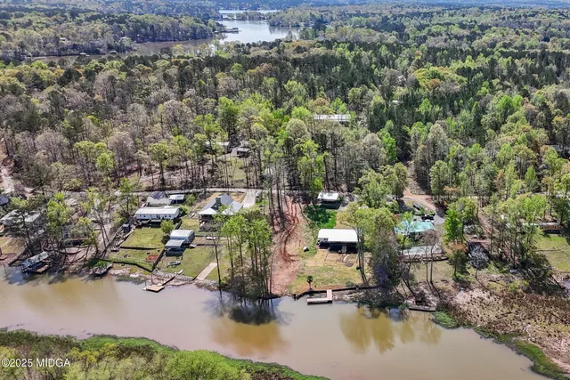 an aerial view of a houses with yard