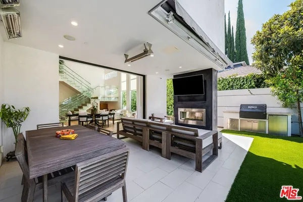 a living room with furniture fireplace and flat screen tv