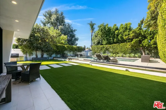 a view of a house with swimming pool and sitting area