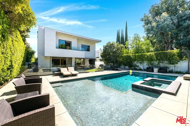 a living room with furniture potted plant and a flat screen tv