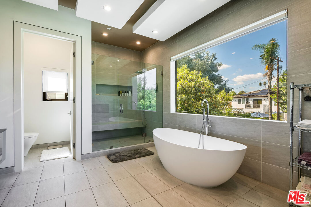 5101 Rubio Avenue Encino, CA 91436 - Photo 19 of 23 a spacious bathroom with a bathtub and shower