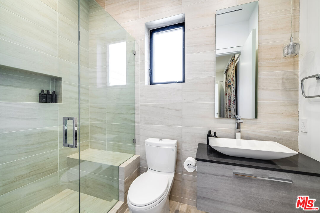 5101 Rubio Avenue Encino, CA 91436 - Photo 21 of 23 a bathroom with a toilet a sink and mirror