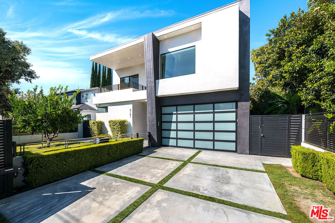 5101 Rubio Avenue Encino, CA 91436 - Photo 3 of 23 a front view of a house with a garden and yard