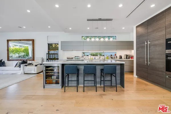 a large kitchen with a table and chairs