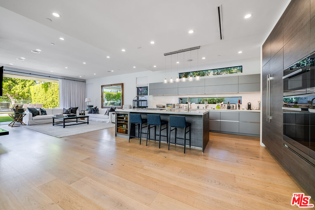 5101 Rubio Avenue Encino, CA 91436 - Photo 6 of 23 a kitchen with stainless steel appliances lots of counter space and furniture