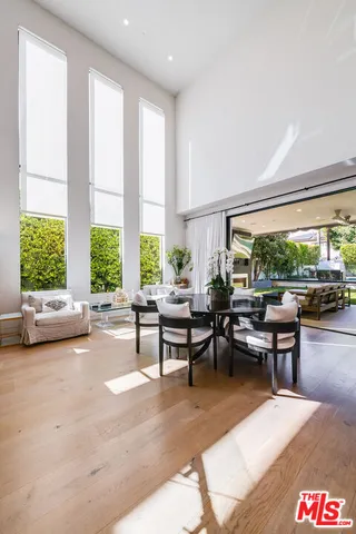 a room with pool table and a chairs