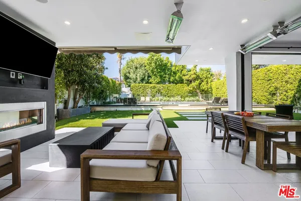 a room with pool table and a chairs