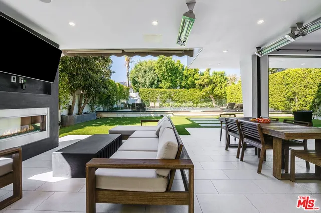 a living room with furniture fireplace and flat screen tv