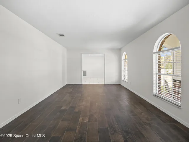 a kitchen with a sink window and cabinets