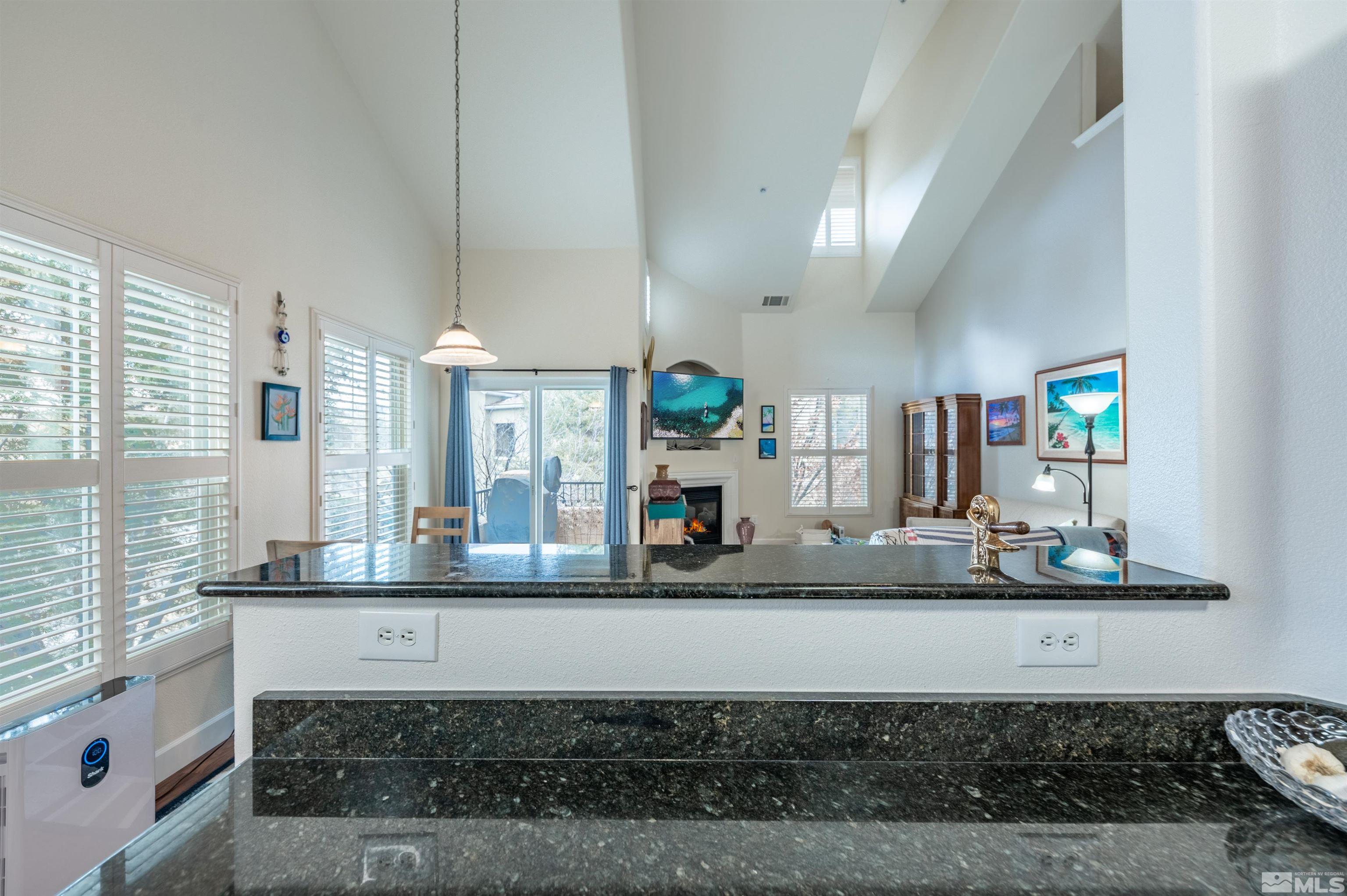 9050 Double R Boulevard, Unit 1925 Reno, NV 89521 - Photo 11 of 32 a large white kitchen with granite countertop a sink and a stove