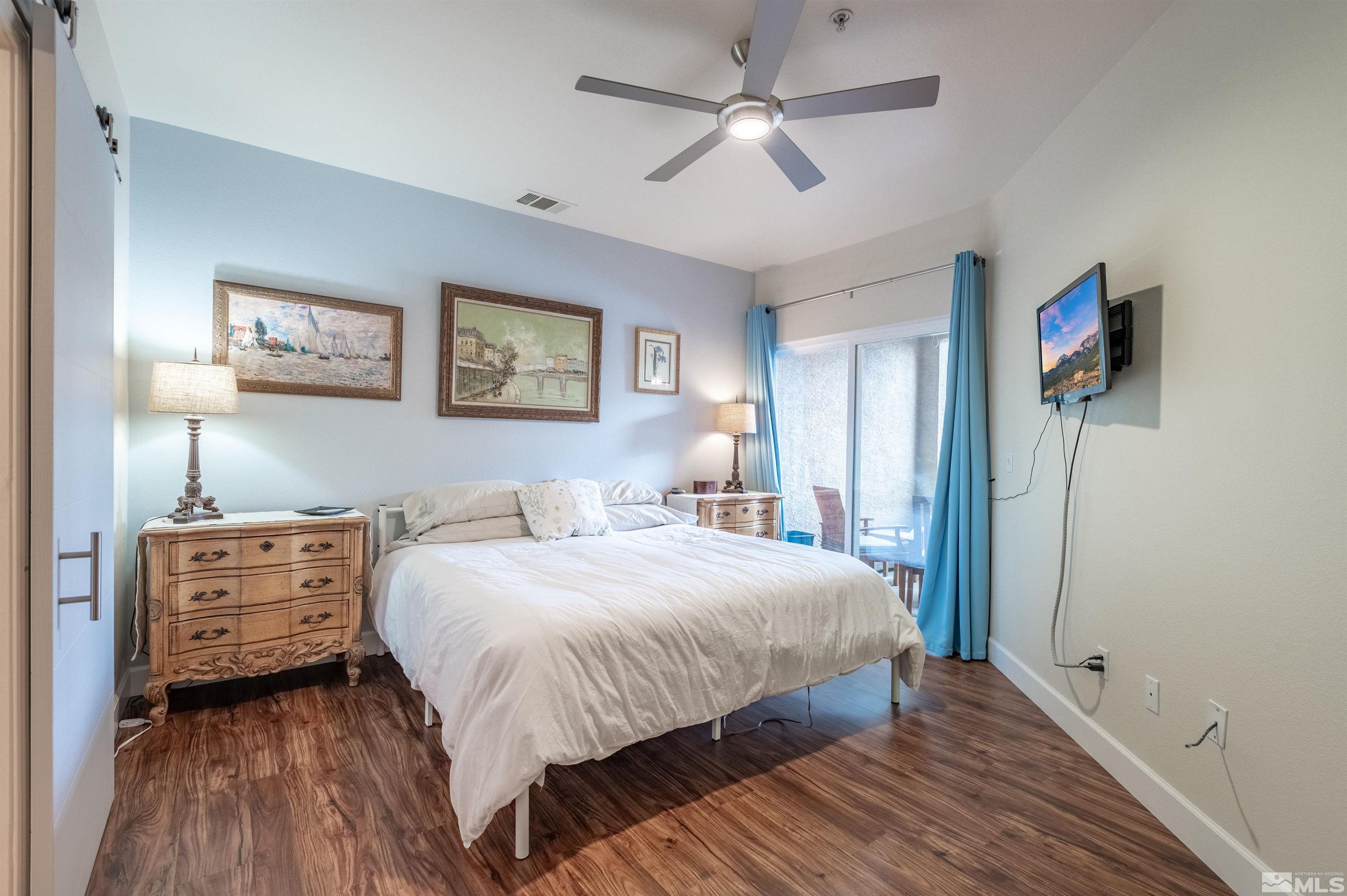 9050 Double R Boulevard, Unit 1925 Reno, NV 89521 - Photo 12 of 32 a bedroom with a bed and a chandelier