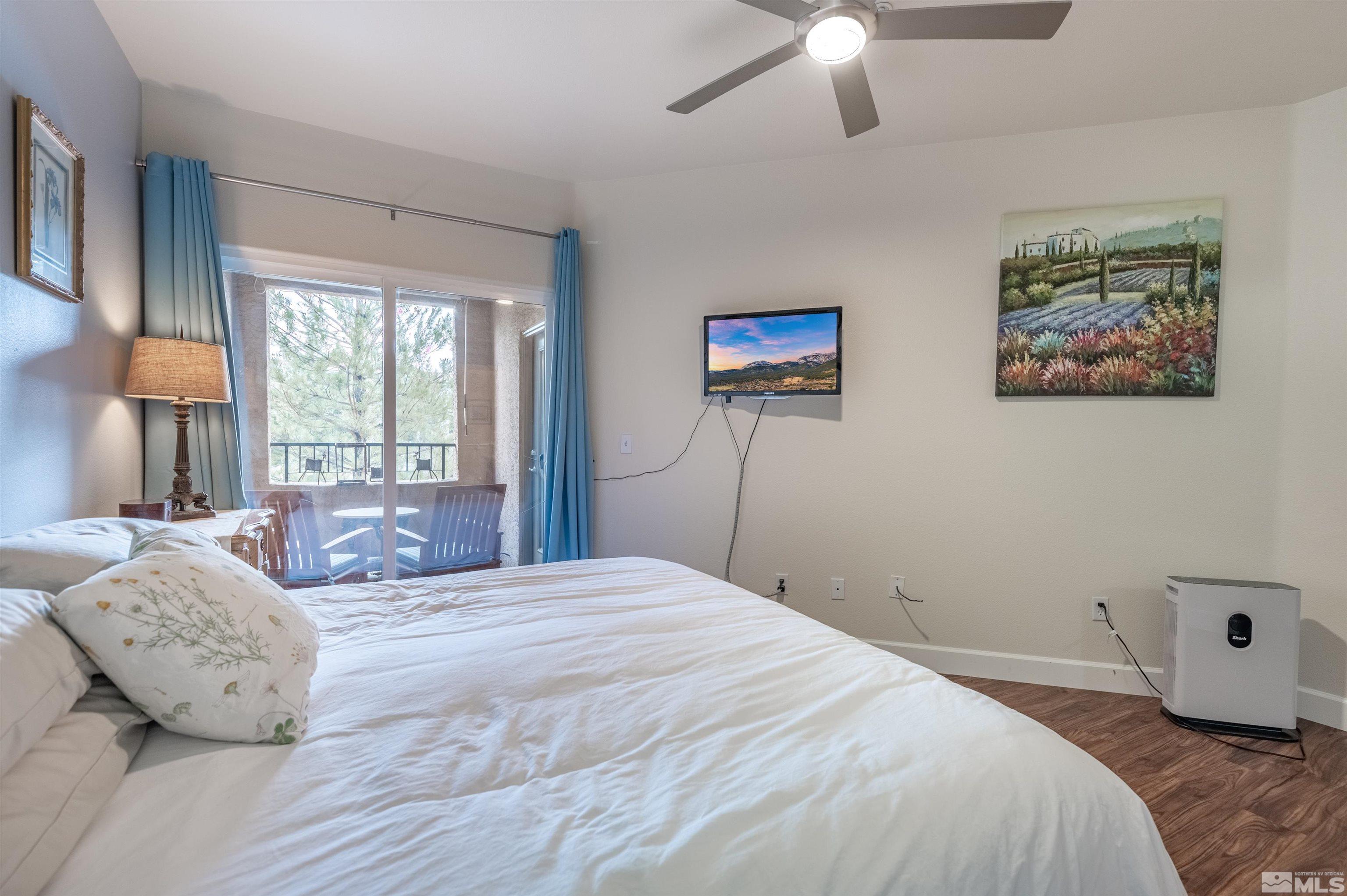 9050 Double R Boulevard, Unit 1925 Reno, NV 89521 - Photo 13 of 32 a bedroom with a bed and a painting on the wall