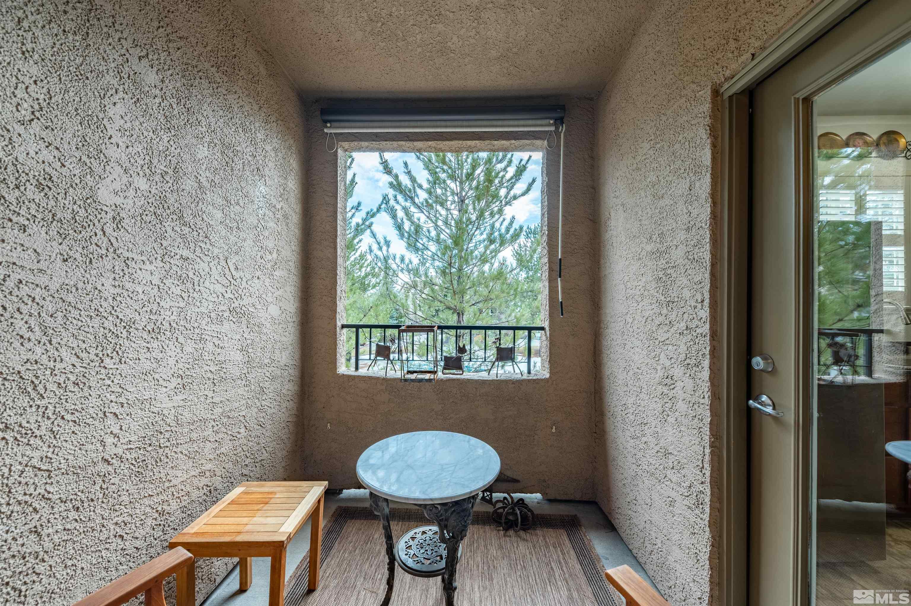 9050 Double R Boulevard, Unit 1925 Reno, NV 89521 - Photo 14 of 32 a room with a chair and a window