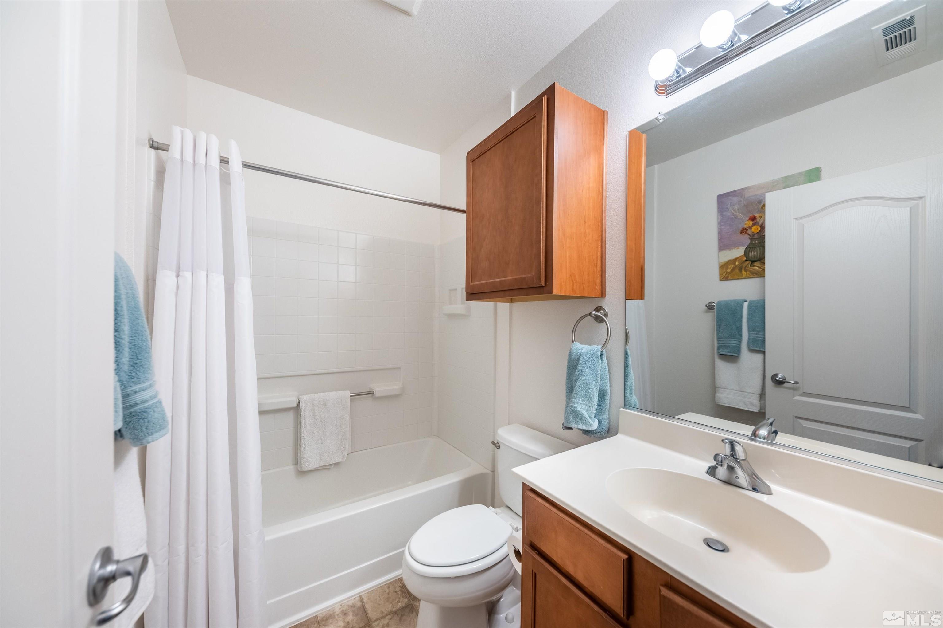 9050 Double R Boulevard, Unit 1925 Reno, NV 89521 - Photo 18 of 32 a bathroom with a sink a toilet and shower