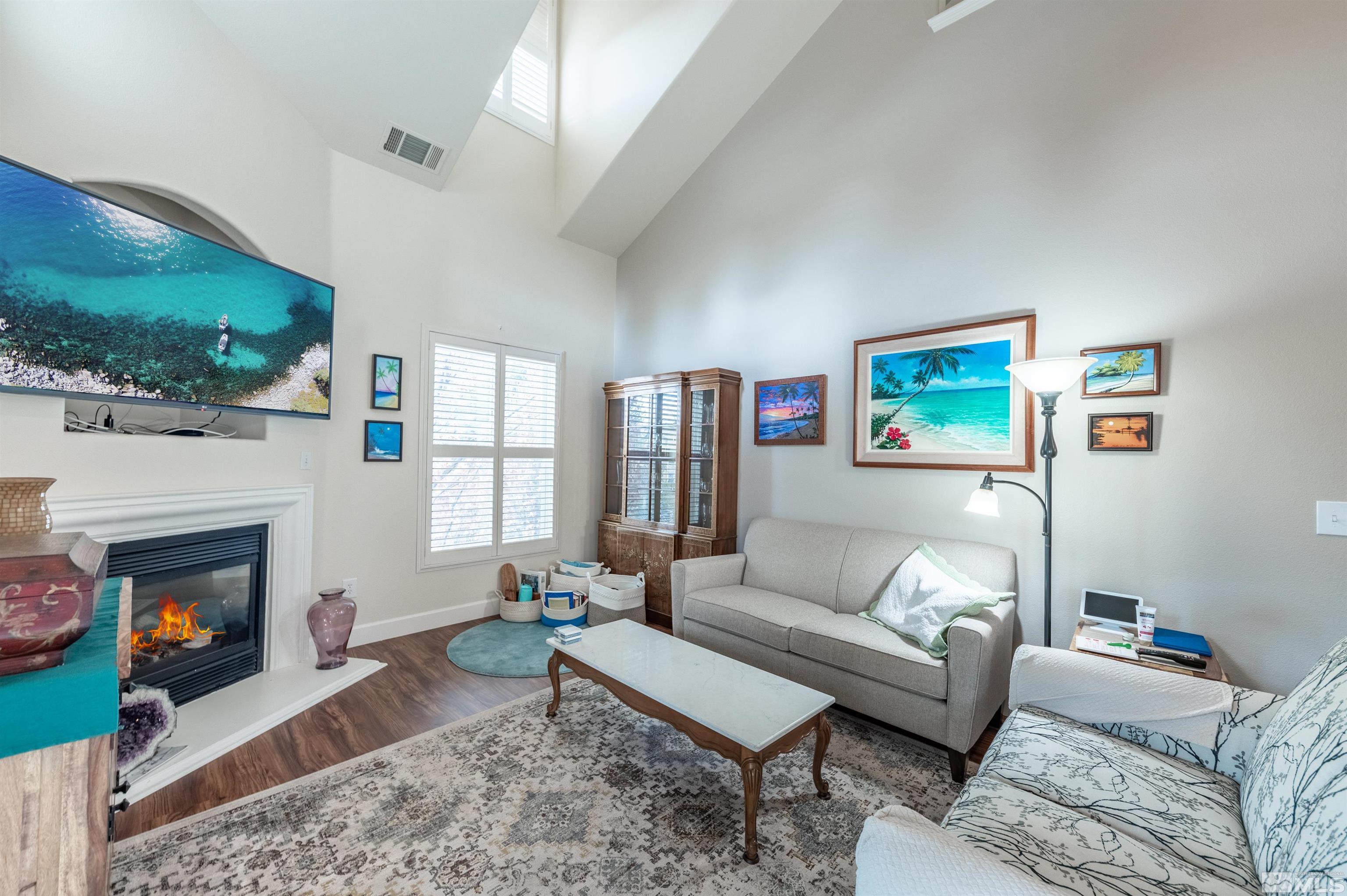 9050 Double R Boulevard, Unit 1925 Reno, NV 89521 - Photo 4 of 32 a living room with furniture and a fireplace