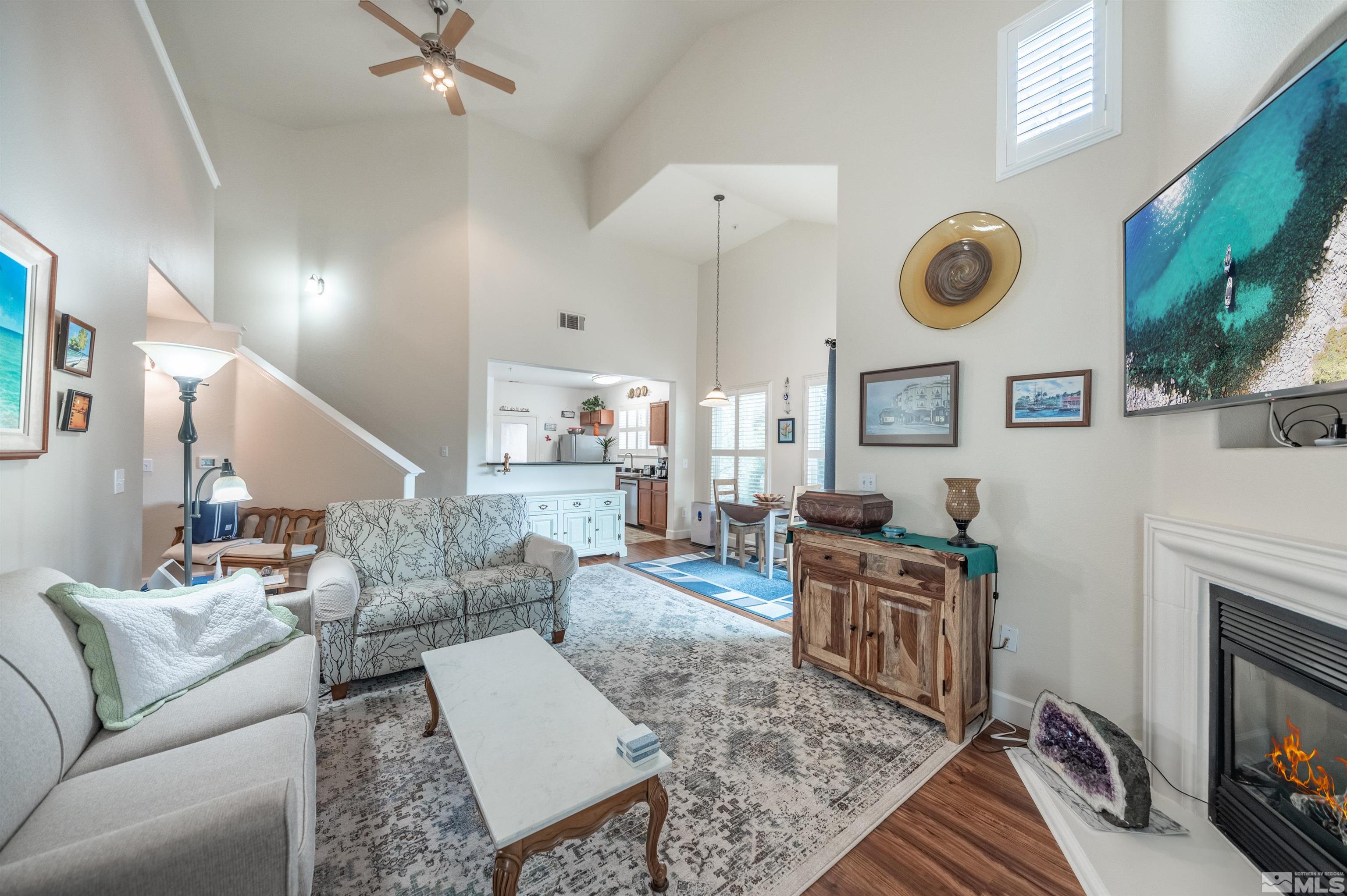 9050 Double R Boulevard, Unit 1925 Reno, NV 89521 - Photo 5 of 32 a living room with furniture and a fireplace