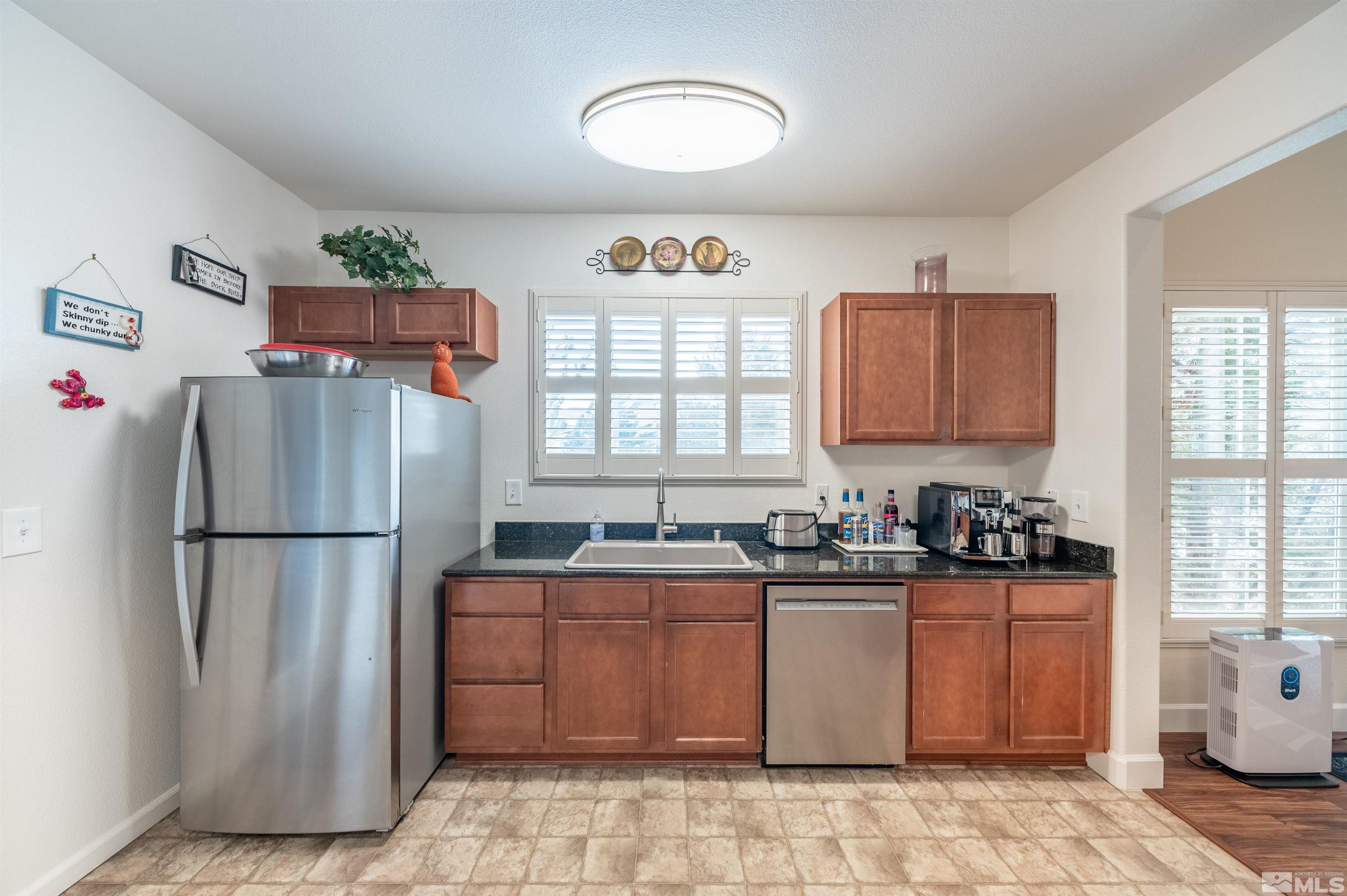 9050 Double R Boulevard, Unit 1925 Reno, NV 89521 - Photo 9 of 32 a kitchen with stainless steel appliances granite countertop a refrigerator sink and cabinets
