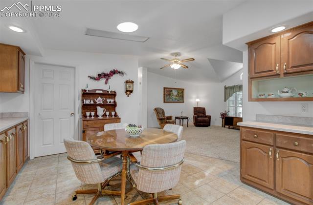 12825 Garrett Road Peyton, CO 80831 - Photo 20 of 47 Carpeted dining room with ceiling fan and lofted ceiling