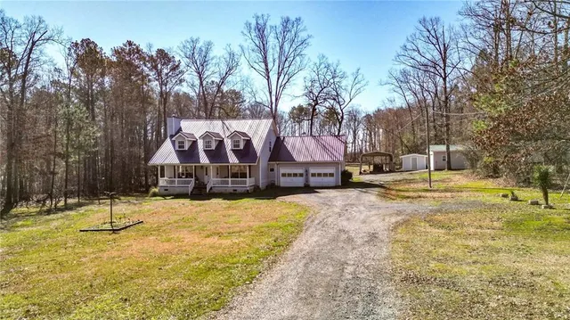 a view of a large house with a yard and trees