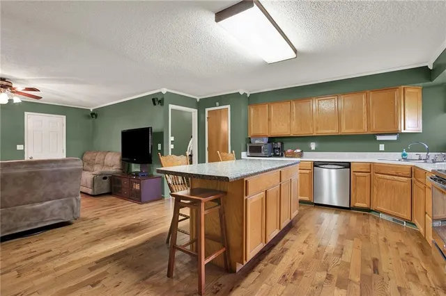 a kitchen with sink and refrigerator
