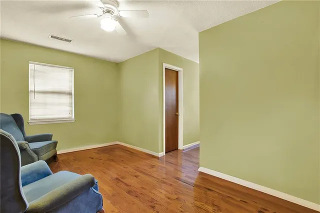 a bedroom with a bed couch and a window