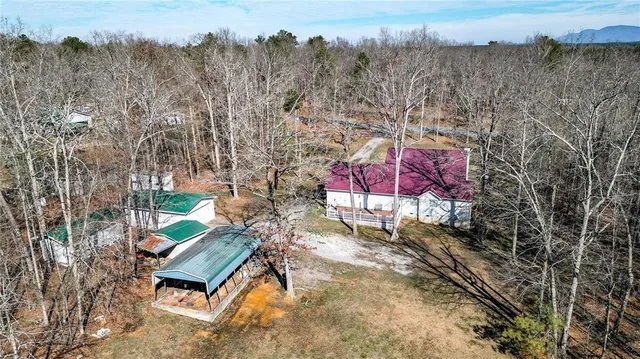 a view of a house with a yard and sitting area