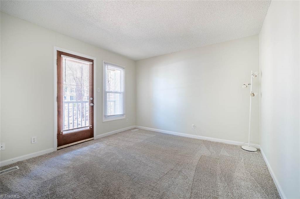 121 Westview Drive, Unit 43 Carrboro, NC 27510 - Photo 9 of 15 Master bedroom w/door to private deck