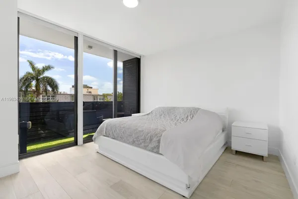 a bedroom with a bed and a mirror