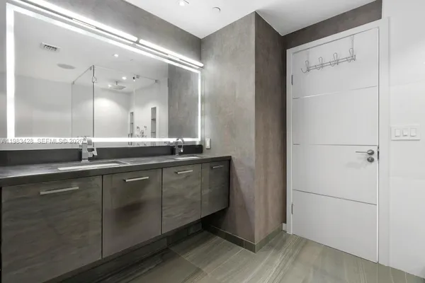 a bathroom with a double vanity sink and mirror
