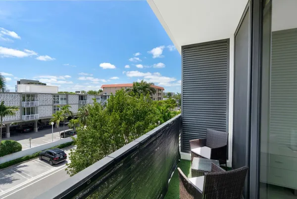 a view of a chair and table in the balcony