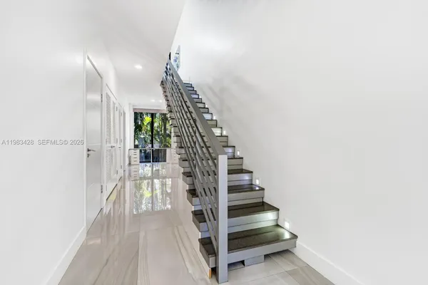 a view of entryway and hall with wooden floor