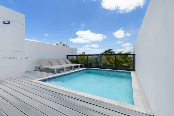 a view of swimming pool with seating space
