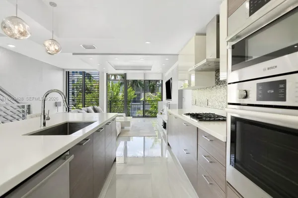 a kitchen with stainless steel appliances granite countertop a sink and stove top oven