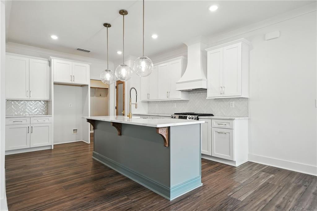 125 Old Alabama Road Southeast Emerson, GA 30137 - Photo 5 of 37 a kitchen with kitchen island granite countertop a sink cabinets and wooden floor