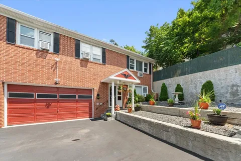a view of a house with sitting area and potted plants