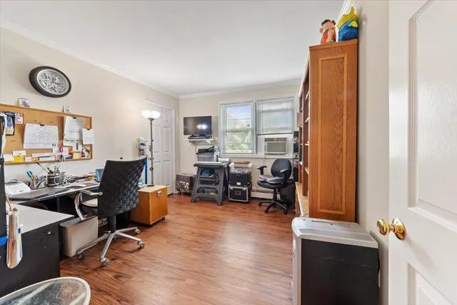 a view of a workspace with furniture and a window