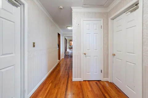 a view of hallway with wooden floor