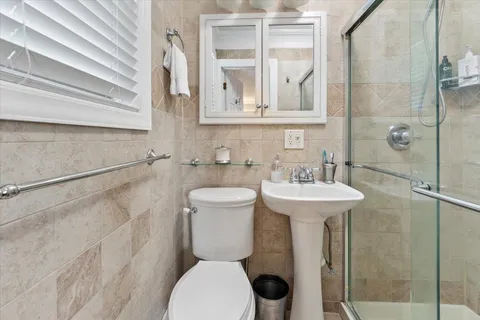 a bathroom with a toilet sink and shower