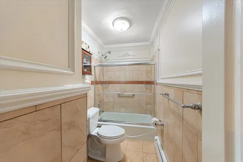 a bathroom with a shower a toilet and sink