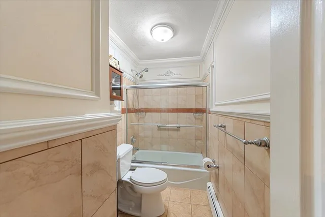 a bathroom with a shower a toilet and sink