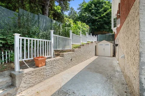 a backyard of a house with wooden floor and fence