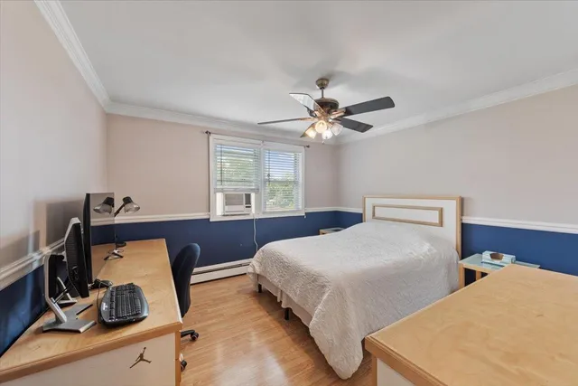 a bedroom with two beds and a window